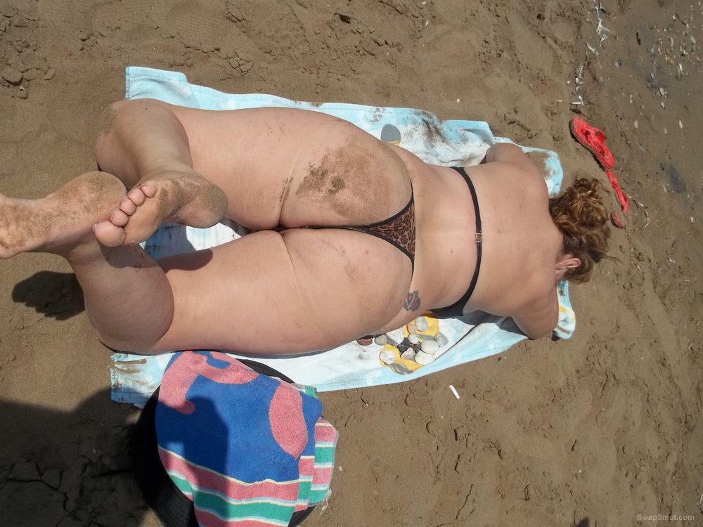 Thong Beach Movies - Sexy wife on beach sunbathing pulling thong to side showing pussy