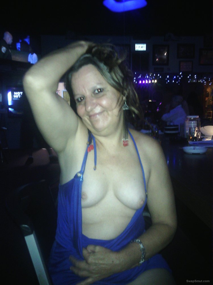 Having a little daring fun at the bar in her slutty blue dress