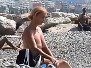 Hot MILF gets naked at the beach and shows off her impressive assets